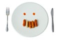 Sausage face on white dish Royalty Free Stock Photo