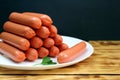 Sausages on a white plate stacked in the form of a tower