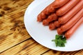 Sausages on a white plate stacked in the form of a tower