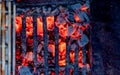 Sausage. Fried meat sausages on a grill grate on the background of hot coals. Juicy sausages on coals. View from above Royalty Free Stock Photo