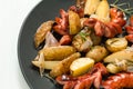 Sausage with fried potatoes and vegetables on a black plate Royalty Free Stock Photo