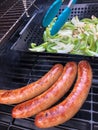 Sausage, Green Peppers and Onions Cooking on the Grill Royalty Free Stock Photo