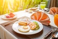 Sausage ham tomato omelets fried egg in a white dish on the table for breakfast