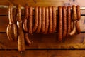 Sausage hanged on wooden background Royalty Free Stock Photo