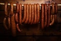 Sausage hanged on wooden background Royalty Free Stock Photo