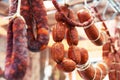 The sausage is hanging on the counter in the store. Trade in meat delicacies. Close-up Royalty Free Stock Photo