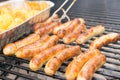 Sausage, hot dogs and potatoes on grill Royalty Free Stock Photo