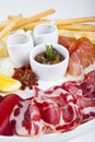 Sausage and jamon snacks with olives, honey and sauce Royalty Free Stock Photo