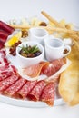 Sausage and jamon snacks with olives, honey and sauce Royalty Free Stock Photo