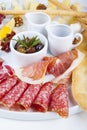 Sausage and jamon snacks with olives, honey and sauce Royalty Free Stock Photo