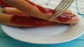 Sausage with ketchup plate fork slow motion