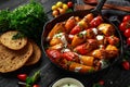 Sausage meat, mince and rice Stuffed sweet mini bell peppers baked in cast iron skillet, pan topped with yogurt and Royalty Free Stock Photo