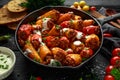 Sausage meat, mince and rice Stuffed sweet mini bell peppers baked in cast iron skillet, pan topped with yogurt and Royalty Free Stock Photo