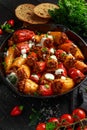 Sausage meat, mince and rice Stuffed sweet mini bell peppers baked in cast iron skillet, pan topped with yogurt and Royalty Free Stock Photo
