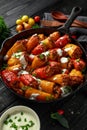 Sausage meat, mince and rice Stuffed sweet mini bell peppers baked in cast iron skillet, pan topped with yogurt and fresh parsley Royalty Free Stock Photo