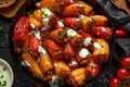 Sausage meat, mince and rice Stuffed sweet mini bell peppers baked in cast iron skillet, pan topped with yogurt and fresh parsley Royalty Free Stock Photo
