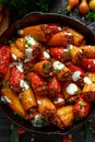 Sausage meat, mince and rice Stuffed sweet mini bell peppers baked in cast iron skillet, pan topped with yogurt and Royalty Free Stock Photo