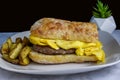 sausage patty top with scramble egg on ciabatta bread