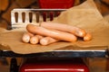 Sausage on red scales Royalty Free Stock Photo