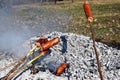 Sausage skewers are heated by grilling on a special slow fire for a long time to eat as a family breakfast on holiday and prepared