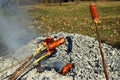 Sausage skewers are heated by grilling on a special slow fire for a long time to eat as a family breakfast on holiday and prepared