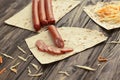 sausage sliced for making a sandwich Shawarma on wooden background Royalty Free Stock Photo
