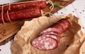 Sausage, sliced pieces close-up on a light background. Side view.