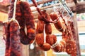 Sausage trade. Meat products are hanging in a shop window. Close-up Royalty Free Stock Photo