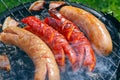Sausages and bacon on the grill, outdoor grilling