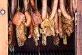 Sausages and bacon inside wooden smokers Royalty Free Stock Photo