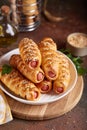 Sausages baked in a yeast dough cover. Pigs in a blanket. Fast food.
