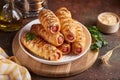 Sausages baked in a yeast dough cover. Pigs in a blanket. Fast food.