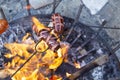 Sausages baking over camp fire. Party with friends