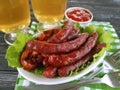 Sausages bratwurst grilled beer snack on a wooden background table Royalty Free Stock Photo