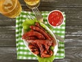 Sausages grilled beer salad recipe cooking on a wooden background table Royalty Free Stock Photo