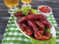 Sausages grilled beer salad recipe cooking beef on a wooden background lettuce table Royalty Free Stock Photo