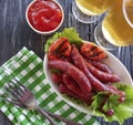 Sausages grilled beer salad recipe parsley beef nutrition on a wooden background lettuce table Royalty Free Stock Photo