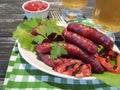 Sausages grilled beer salad recipe parsley nutrition on a wooden background lettuce table Royalty Free Stock Photo