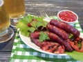 Sausages grilled beer salad recipe homemade nutrition kitchen on a wooden background lettuce table Royalty Free Stock Photo