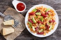 Sausages bowtie Pasta warm salad with avocado slices and cheese Royalty Free Stock Photo