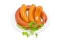 Sausages with branch of coriander on a light background