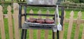 Sausages and burgers cooking on a disposable BBQ Barbeque in s garden Royalty Free Stock Photo