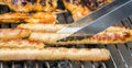 Sausages and chicken wings on smoking grill barbeque Royalty Free Stock Photo