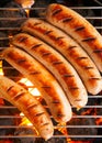 Sausages cooking on a barbecue fire Royalty Free Stock Photo