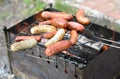 Sausages cooking on a portable barbecue Royalty Free Stock Photo