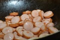 Sausages cut into pieces. Boiled sausage product. the process of cooking.