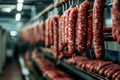 Sausages on drying racks in an industrial setting.