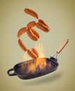 Sausages falling on the grill pan on a gradient isolated background