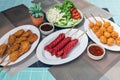 The sausages and fried meatballs made from a variety of meats, mixed with flour and seasonings with a delicious spicy sauce and Royalty Free Stock Photo