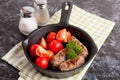 Sausages in a frying pan on black background. Fresh tomate Royalty Free Stock Photo